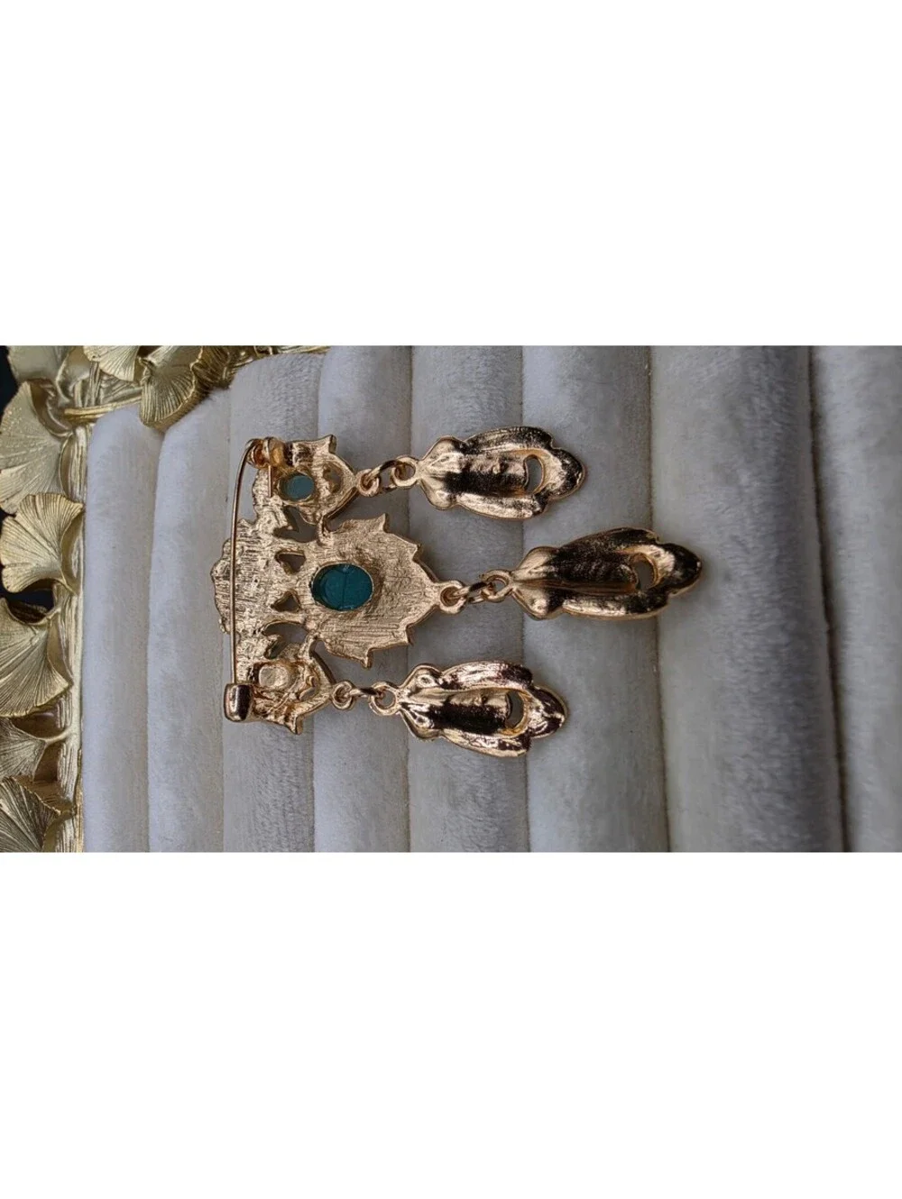 Vintage-Inspired Teal Gemstone Brooch with Dangling Design